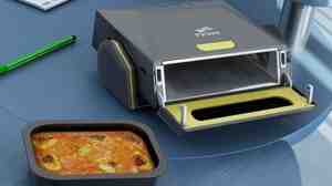 When not in use, this desk oven can be stowed upright and can serve as a whiteboard.