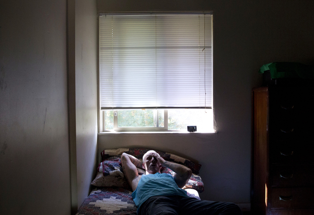 Dan Huff rests after a long day's work. He spent much of his life incarcerated in the California prison system. Now, he lives in drug- and alcohol-free transitional housing in Portland, Ore. (Image credit: Beth Nakamura for NPR)