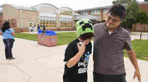 Lindolfo Carballo, an immigrant from El Salvador, meets his son, Raynel, outside school. In El Salvador, he says, families often "teach their boys one thing and their girls differently." He's trying to set a different example for his children.
