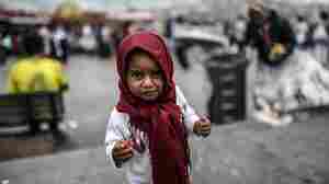 A Syrian refugee child eats food which her mother collected from rubbish in the Eminonu disctrict of Istanbul.