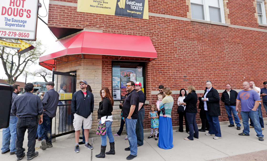 Aficionados line up outside Hot Doug's, a gourmet hot dog diner in Chicago, in May. Owner Doug Sohn has announced that he will shut the doors in October after nearly 14 years.