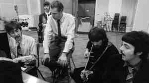The Beatles with George Martin in January 1967 at Abbey Road Studios in London.