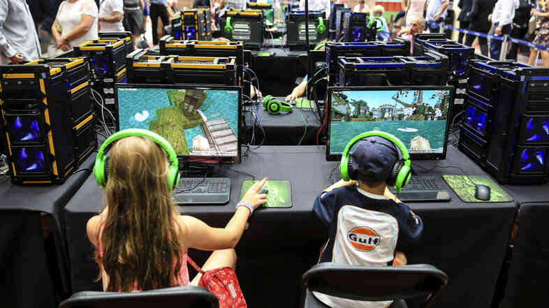 Two youngsters play in a Minecraft tournament Aug. 9 in Ascot, England.
