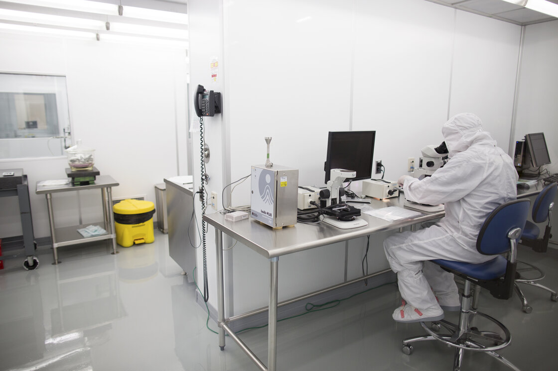 An employee works in a clean room at Exelis. Mike Ognenovski, the company's vice president of operations, says he wants to make the work here "more of a science versus an art." An employee works in a clean room at Exelis. Mike Ognenovski, the company's vice president of operations, says he wants to make the work here "more of a science versus an art."
