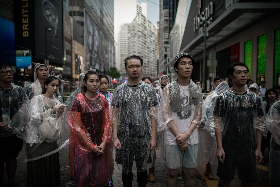 Pro-democracy demonstrators look on as they protect a barricade from opponents in an occupied area of Hong Kong on Friday. Pro-democracy demonstrators look on as they protect a barricade from opponents in an occupied area of Hong Kong on Friday.