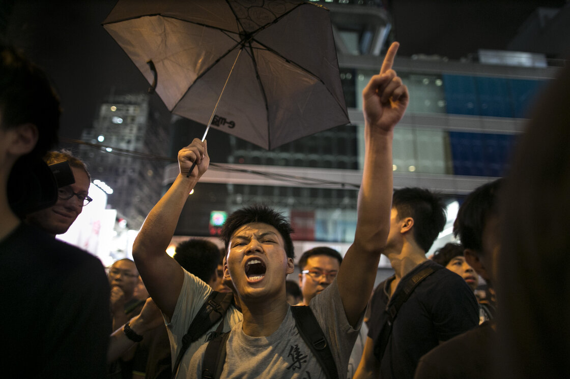 Police are trying to control the crowds in the Mong Kok neighborhood as residents of Kowloon who are pro-Beijing clash with pro-democracy protesters, screaming at them to "get out." Police are trying to control the crowds in the Mong Kok neighborhood as residents of Kowloon who are pro-Beijing clash with pro-democracy protesters, screaming at them to "get out."