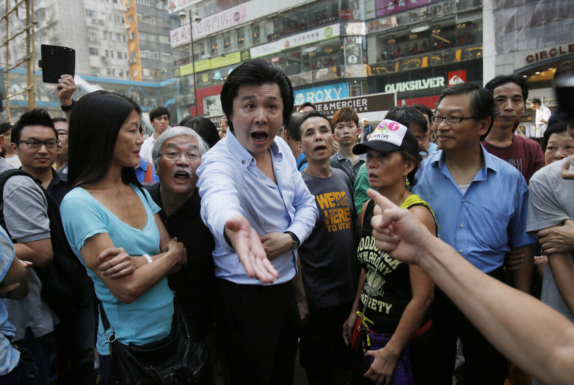 Angry locals confront pro-democracy student protesters, demanding that they remove the barricades blocking local streets in Causeway Bay. Angry locals confront pro-democracy student protesters, demanding that they remove the barricades blocking local streets in Causeway Bay.