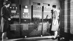 Jean Jennings (left) and Frances Bilas set up the ENIAC in 1946. Bilas is arranging the program settings on the Master Programmer.