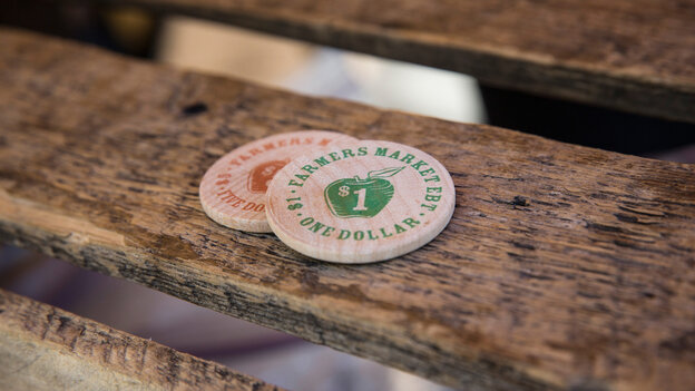 Tokens representing $1, which can be used specifically for fresh fruits and vegetables, are displayed at a Electronic Benefits Transfer, or food stamp, station in the GrowNYC Greenmarket in Union Square on September 18, 2013 in New York City.