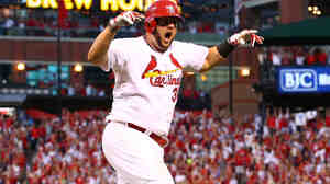 Matt Adams of the St. Louis Cardinals reacts after hitting a three-run home run in the seventh inning against the Los Angeles Dodgers in Game 4 of the National League Division Series.