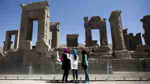 Iranian women look at the palace of King Darius of Achaemenid Persepolis, near Shiraz in southern Iran.