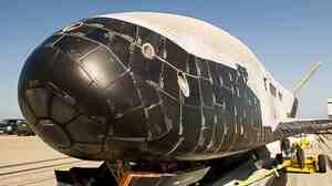 This photo released by Vandenberg Air Force Base on Monday shows the X-37B Orbital Test Vehicle, the Air Force's unmanned, reusable space plane, after it landed at Vandenberg from a previous orbital mission.
