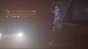 Nina Pham, 26, steps off a plane Thursday night at a municipal airport in Frederick, Md. An ambulance was waiting to take her to the National Institutes of Health in Bethesda, Md.