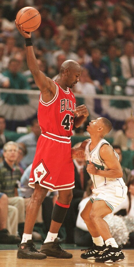 Chicago Bulls' Michael Jordan (left) looks down on Muggsy Bogues during a game in 1995. Bogues, who stands at 5' 3", is the shortest player in NBA history.