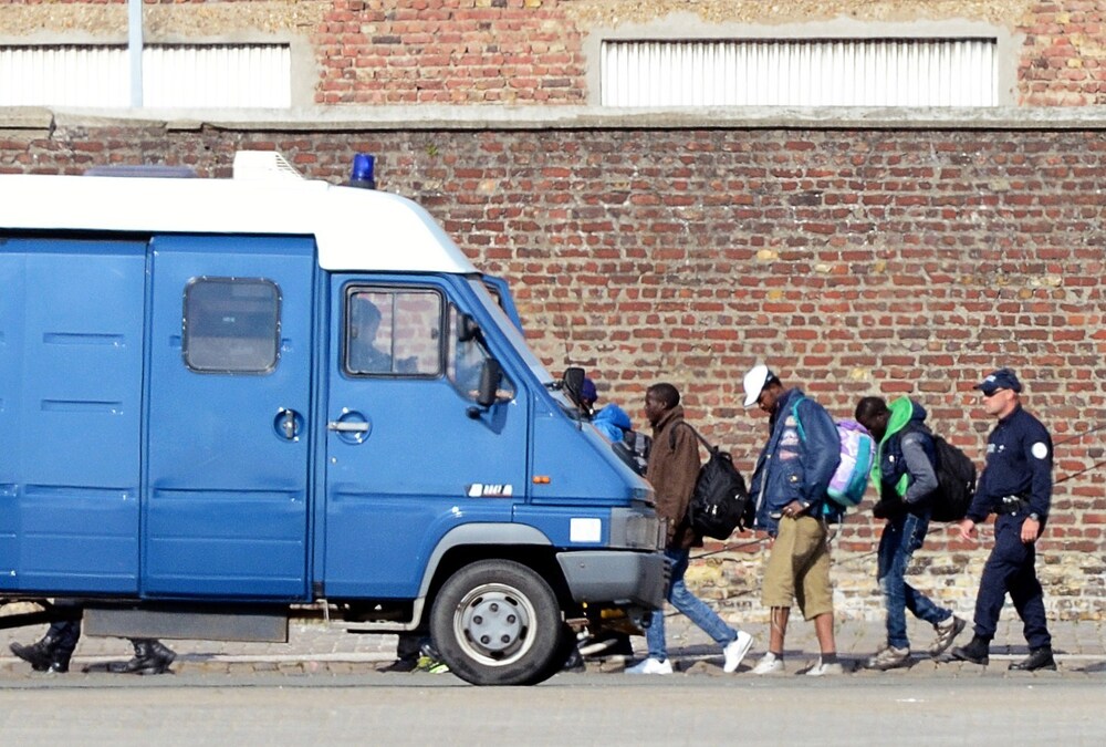French policemen expel illegal migrants from their camp in Calais on July 2.
