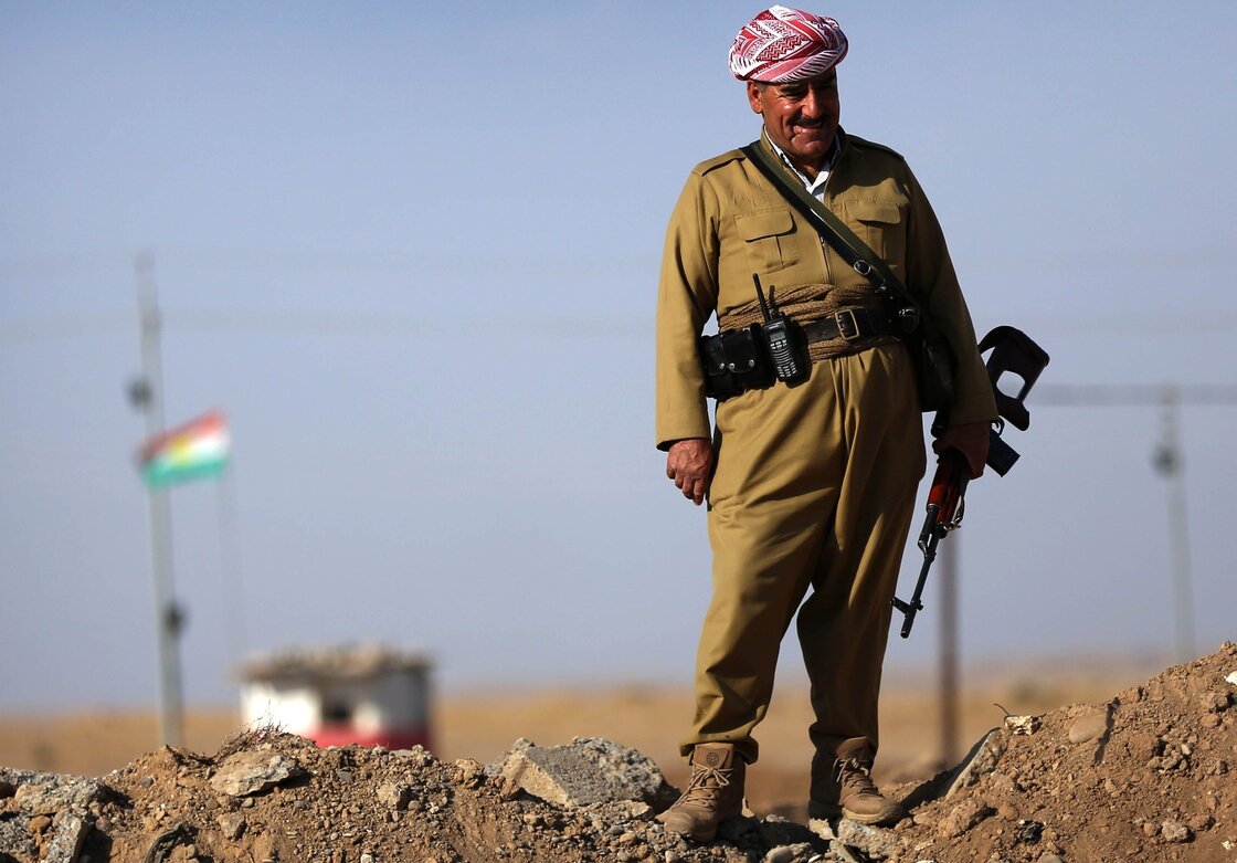 An Iraqi Kurdish peshmerga fighter stands on a berm 25 miles south of Irbil, the capital of the Kurdish region in northern Iraq, on Oct. 5. Turkish Kurds have been joining the Iraqi Kurds in the fight against the Islamic State.