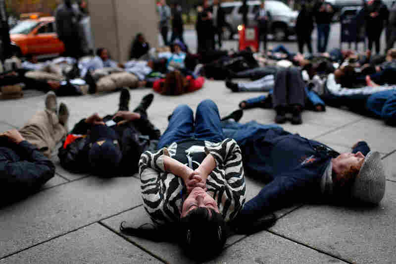 Joy Cooney takes part in a "die-in" during a protest outside the Office of Police Complaints as part of a planned "28 Hours for Mike Brown" in Washington, D.C. 