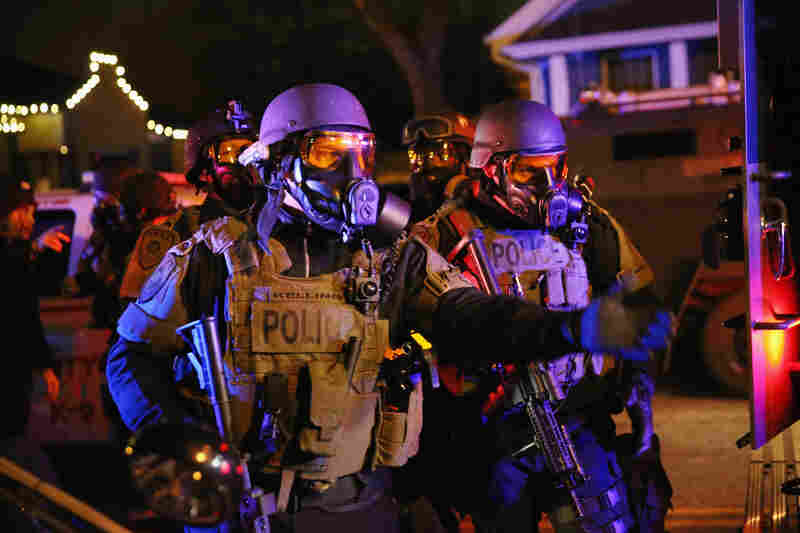 Police confront protesters after rioting broke out in Ferguson on Monday night. Ferguson has been struggling to return to normal after Brown was killed by Wilson on Aug. 9.