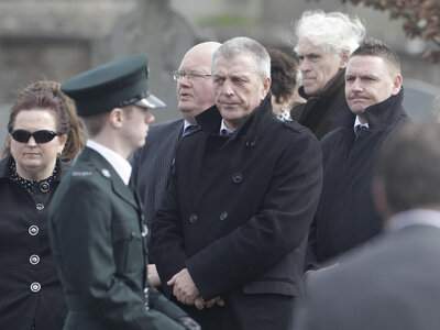 Jackie McDonald (center), is shown here at a funeral in 2011. He once ran the Ulster Defence Association, the biggest Protestant paramilitary group in Northern Ireland. Now, he works for a group that seeks peace. But he says many young people don't seem to want resolution: "They've heard stories about their grandfather or their uncle. So these young people think they've missed out." Jackie McDonald (center), is shown here at a funeral in 2011. He once ran the Ulster Defence Association, the biggest Protestant paramilitary group in Northern Ireland. Now, he works for a group that seeks peace. But he says many young people don't seem to want resolution: "They've heard stories about their grandfather or their uncle. So these young people think they've missed out."