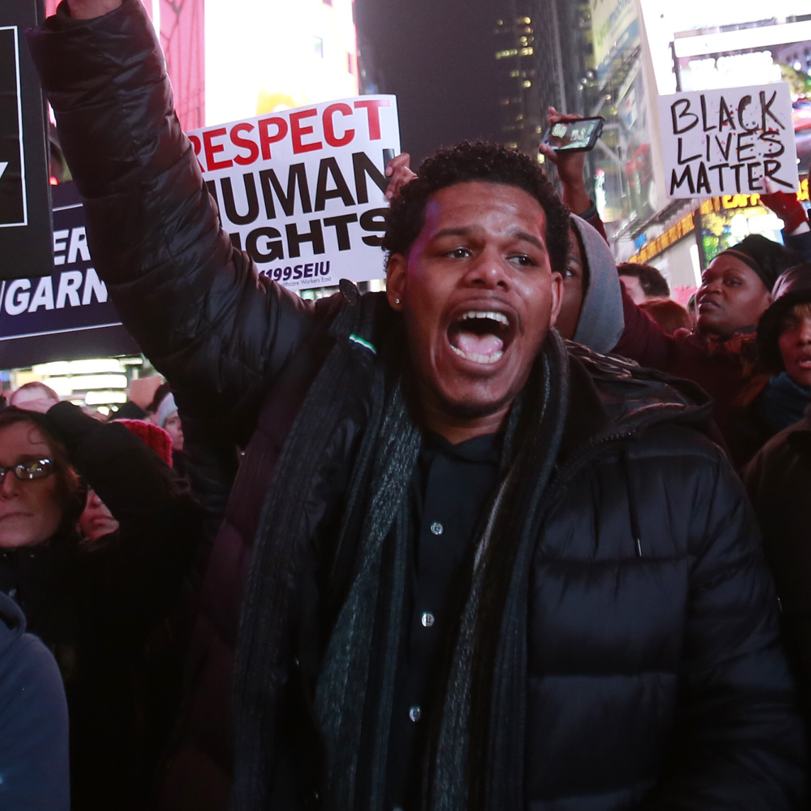 Protesters shout slogans in New York City's Times Square on Wednesday. A New York City grand jury has decided not to charge a police officer who killed Eric Garner with a chokehold while trying to arrest him for illegally selling cigarettes.