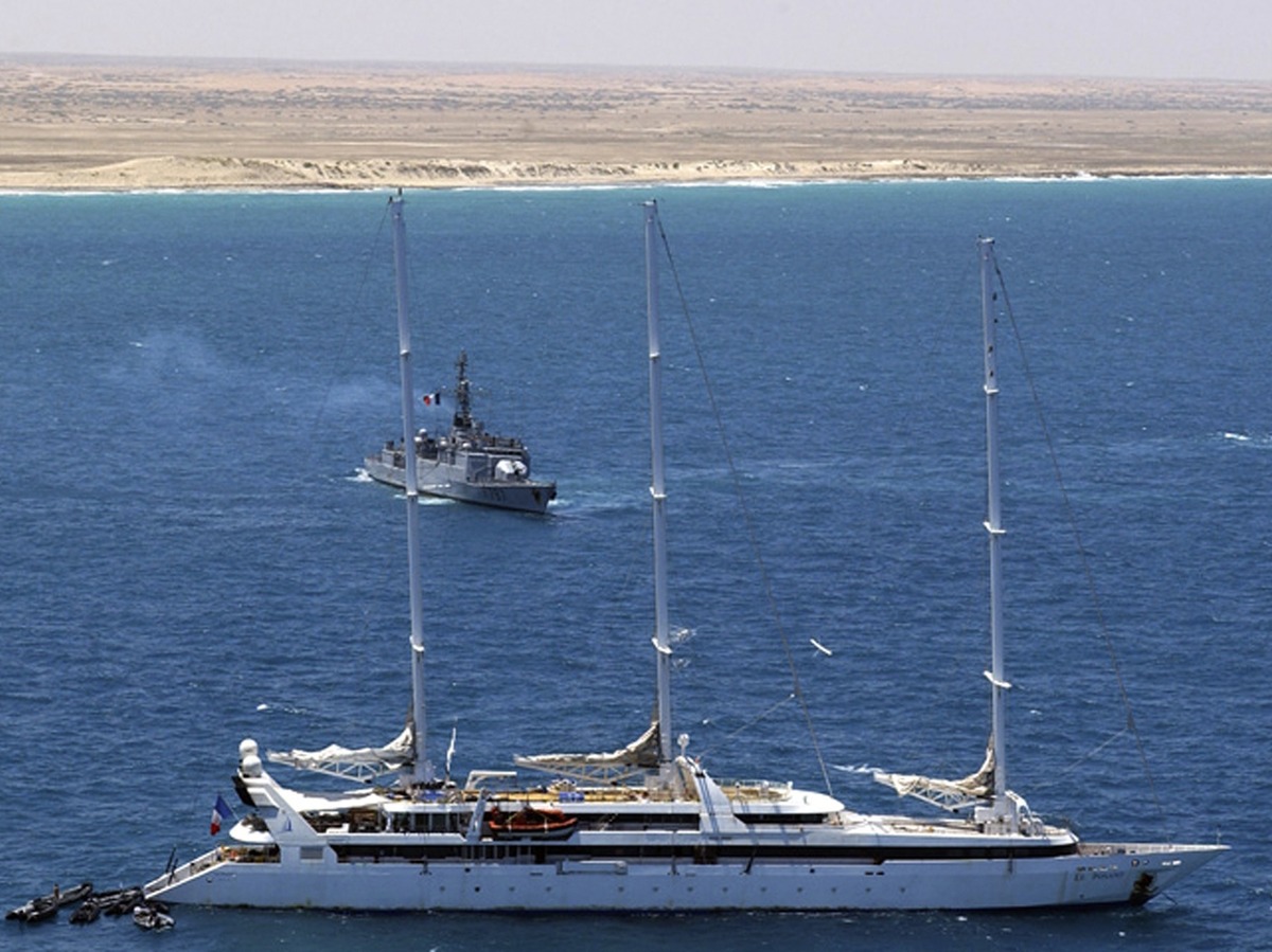 Zodiac commando boats arrive at the rear of the French luxury yacht Le Ponant, whose crew was held hostage by pirates, in April 2008. The French navy frigate Le Commandant Bouan is seen in the background, off Somalia's coast.