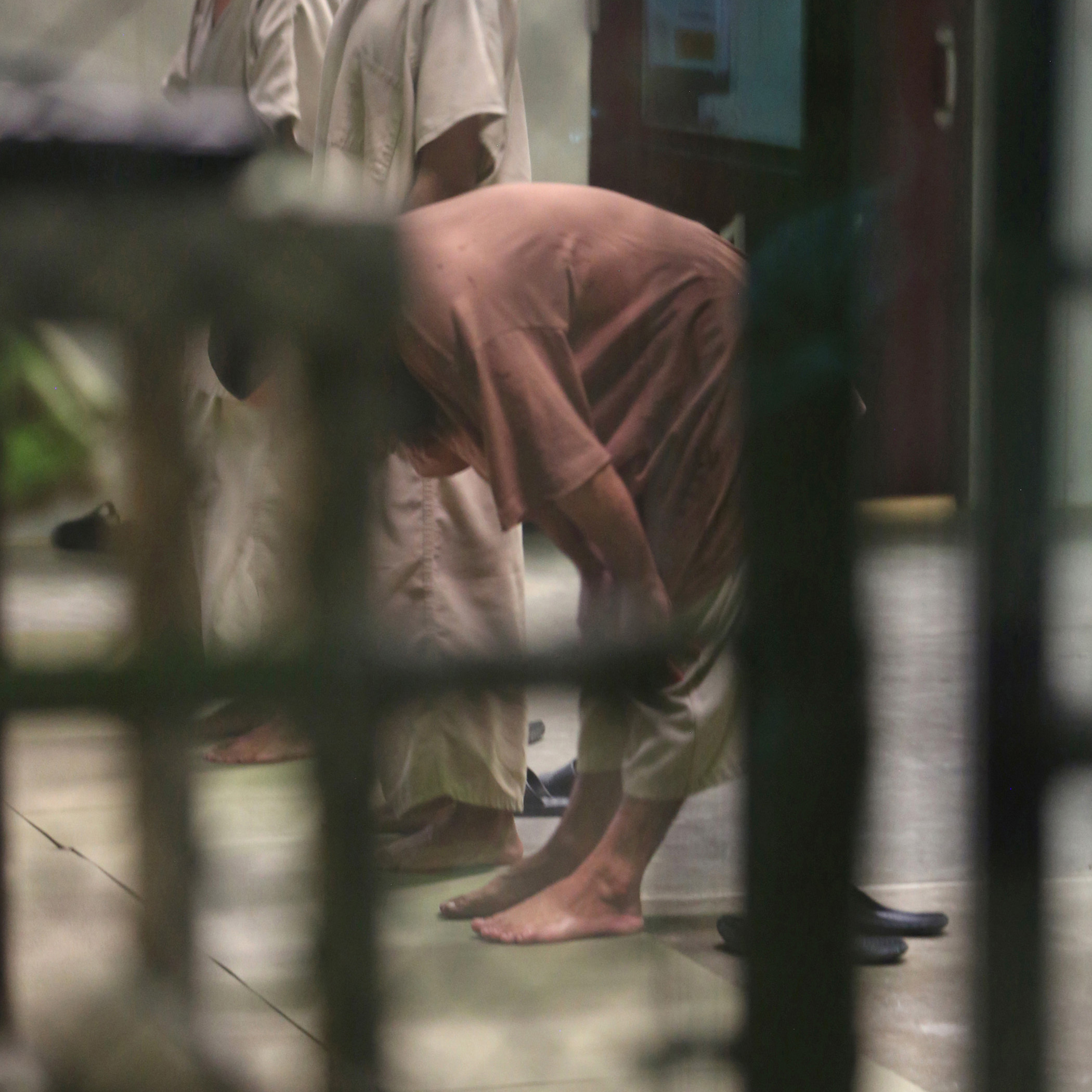 Cooperative captives conduct afternoon prayers inside a communal cellblock at Camp 6 last month at the U.S. Navy base at Guantanamo Bay, Cuba. Six long-time detainees of the prison have been transferred to Uruguay.