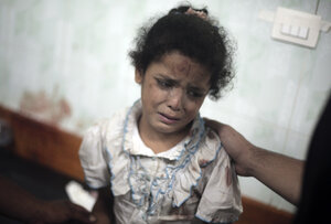 A Palestinian girl cries while receiving treatment at a hospital in the Gaza Strip following shelling in July of a U.N. school in the Jebaliya refugee camp.