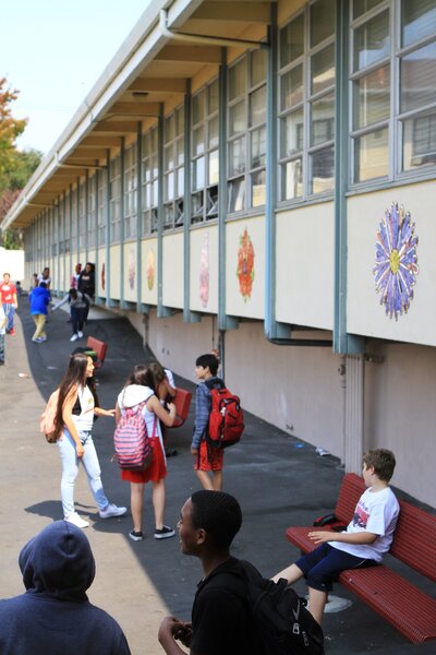 Students congregate outside at Edna Brewer Middle School. The hope of restorative justice is that dialogue builds trust and community and reduces the need for suspensions and expulsions.