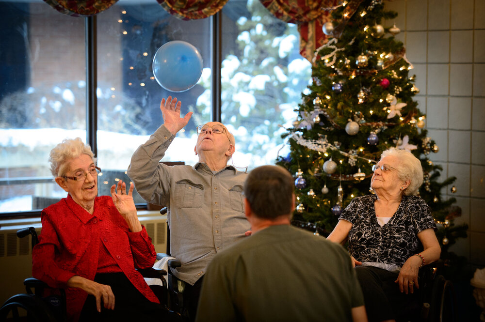 Marian Grunwald (from left), Earl Elfstrom and Verna Matheson bounced a balloon back and forth with nursing assistant Rick Pavlisich on Dec. 13, 2013, at an Ecumen nursing home in Chisago City, Minn.