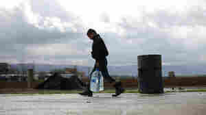A Syrian refugee child carries water in the Fayda Camp, some 25 miles east of Beirut, Lebanon, on March 10.