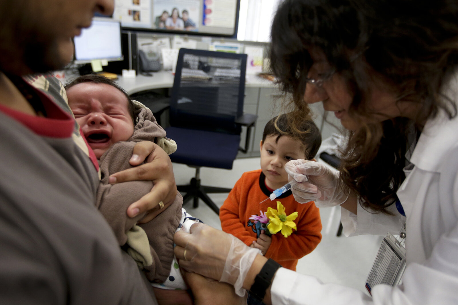 Nurse Julietta Losoyo gives Derek Lucero a whooping cough vaccination at the San Diego Public Health Center on Dec. 10.