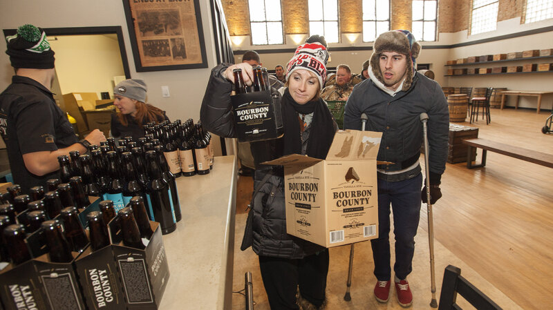 A craft beer fan picks up a six-pack of Goose Island Beer Co.'s limited Black Friday release of Bourbon County Brand Stout on Nov. 26 in Chicago.