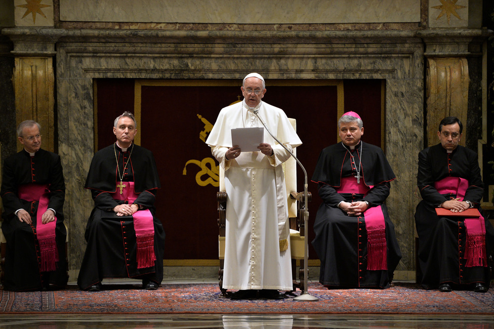 Pope Francis delivers his message during a meeting with cardinals and bishops of the Curia at the Vatican on Monday. The pope said the Curia suffered from 