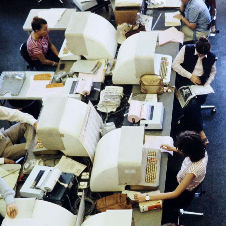 Journalists are seen working on computers in the press room of French press agency Agence France-Presse.