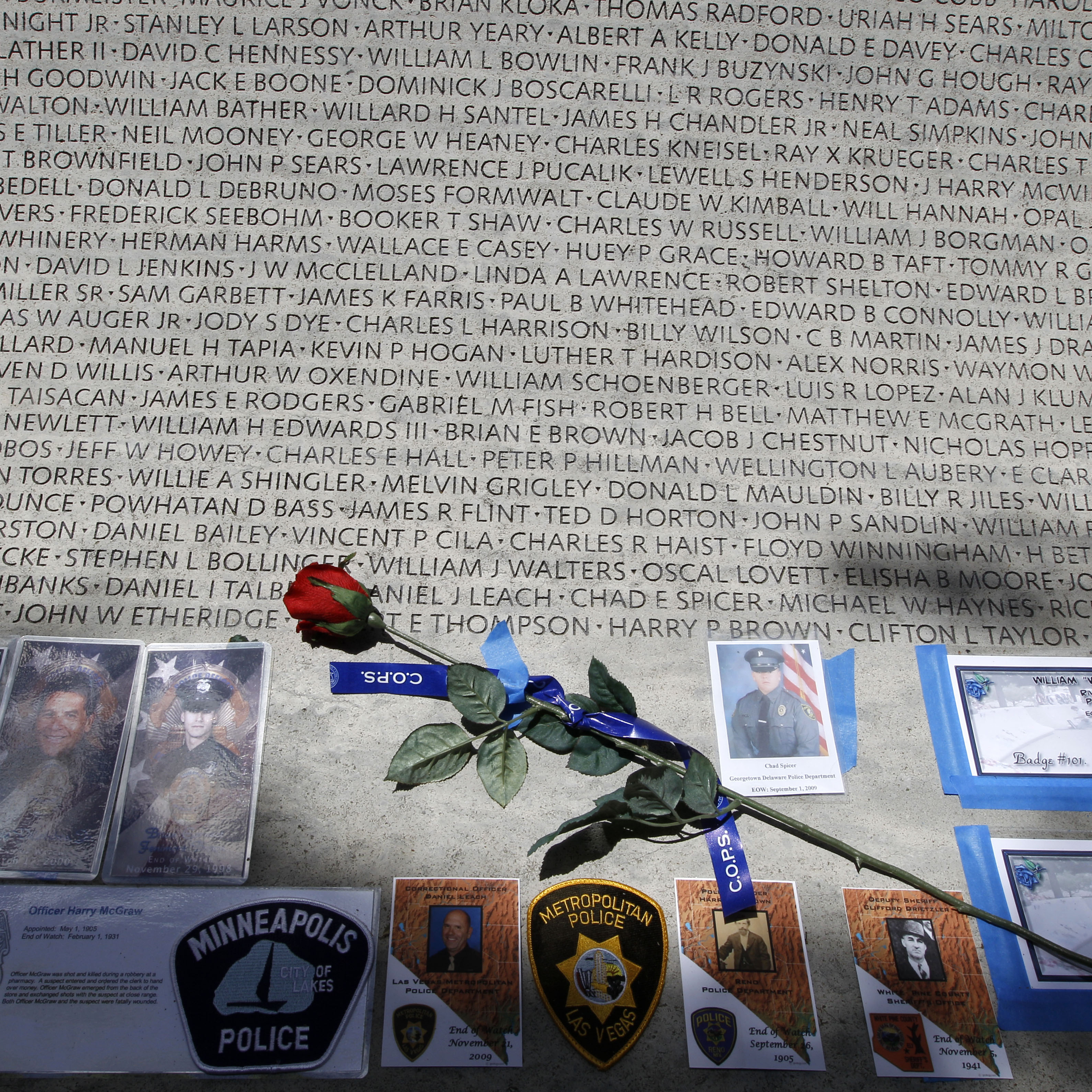 A rose is placed at the wall with the names of fallen police officers at the National Law Enforcement Officers Memorial in Washington during the National Police Week in 2013.