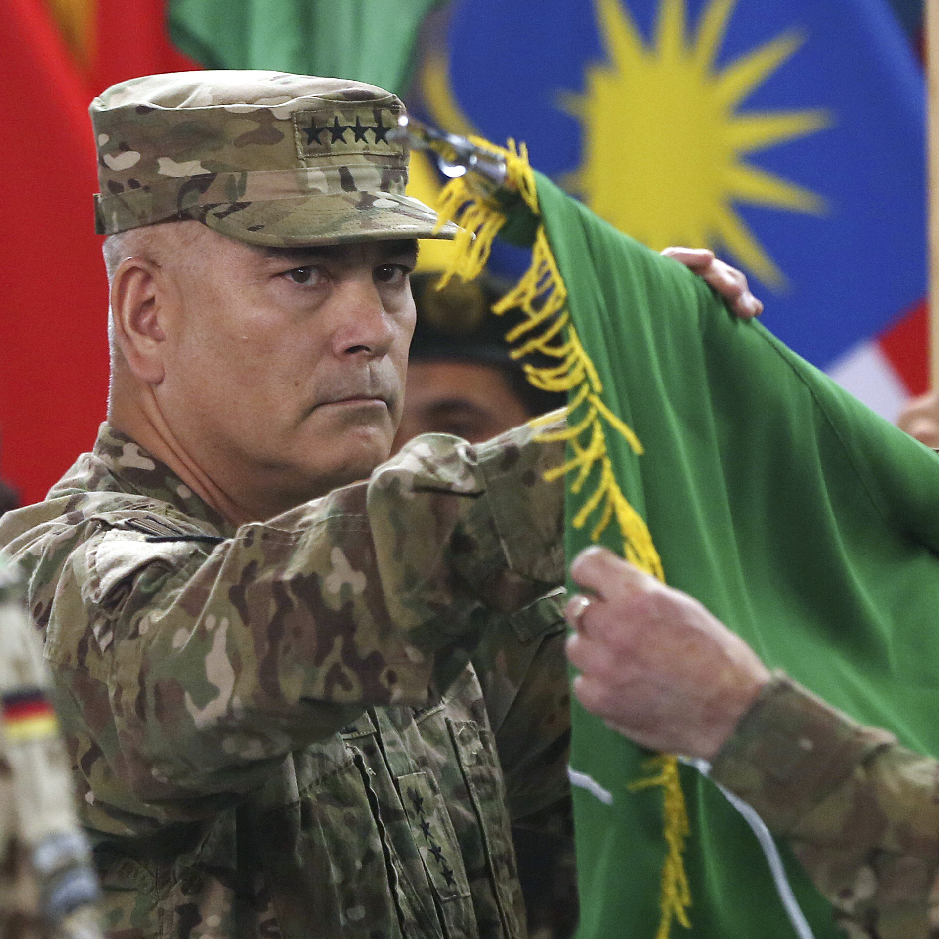 U.S. Gen. John Campbell (left) and Command Sgt. Maj. Delbert Byers open the Operation Resolute Support flag during a ceremony at the International Security Assistance Force headquarters in Kabul, Afghanistan on Sunday.