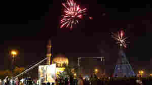 Iraqi crowds cheer as the countdown and fireworks begin during a New Year's Day celebration at Firdos Square in Baghdad on Wednesday.