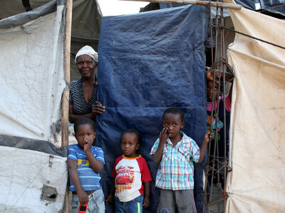 A family looks out from behind the tarp that serves as the front door to their home. The structure was built five years ago over the land where their home stood before the 2010 earthquake. At one point, about 1.5 million people lived in tents across Haiti. Now about 80,000 people live in these structures. A family looks out from behind the tarp that serves as the front door to their home. The structure was built five years ago over the land where their home stood before the 2010 earthquake. At one point, about 1.5 million people lived in tents across Haiti. Now about 80,000 people live in these structures.