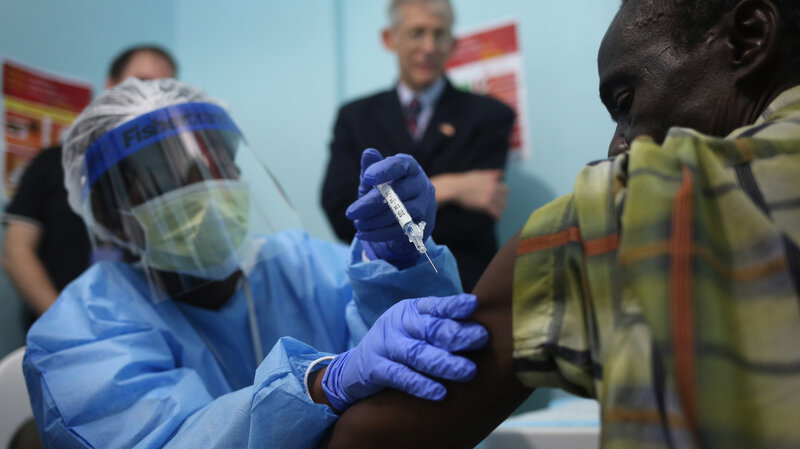 A nurse administers an experimental Ebola vaccine Monday at Redemption Hospital in Monrovia, Liberia. Researchers aim to give shots to 27,000 people during the large trial.