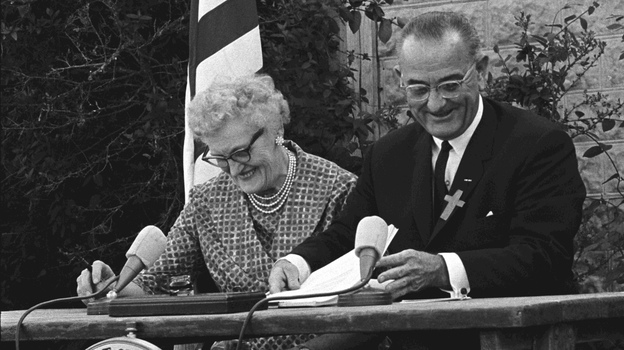 President Lyndon B. Johnson signs the ESEA in 1965 with Kate Deadrich Loney, the President's first schoolteacher. (LBJ Presidential Library)