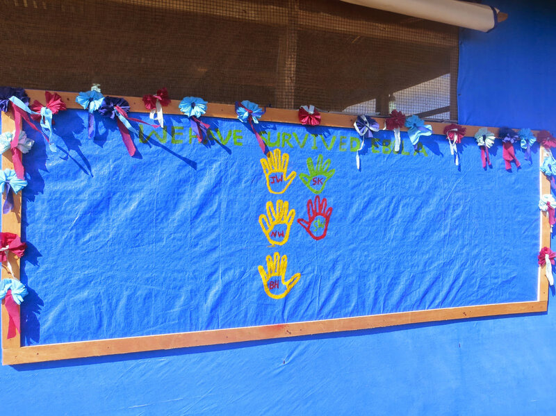 A survival wall is set up at the treatment center with the patients painting their hands and writing their initials on them as they leave. A small triumph.