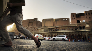 People walk near the Citadel in Erbil last June.