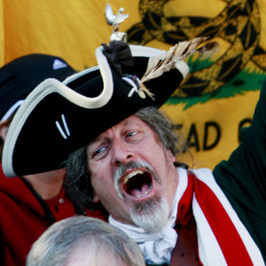 A man holds up a tea kettle during an Atlanta Tea Party tax protest in April 2009.