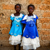 Twins Watta and Fatta Balyon pose for a picture outside their guardian Mamuedeh Kanneh's house.