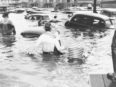 Two men struggle through waistdeep water in the inundated community of Vanport, Ore. on May 30, 1948 with a child, following a break in a dike which allowed water of the Columbia River to sweep through the town. Two men struggle through waistdeep water in the inundated community of Vanport, Ore. on May 30, 1948 with a child, following a break in a dike which allowed water of the Columbia River to sweep through the town.