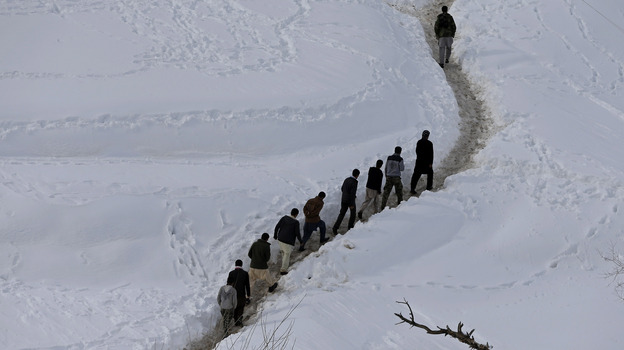 Survivors of an avalanche walk in the Abdullah Khil village of the Dara district of Panjshir province on Sunday. Nearly 200 people have been killed in north Afghanistan in some of the worst avalanches there for 30 years. (Reuters/Landov)