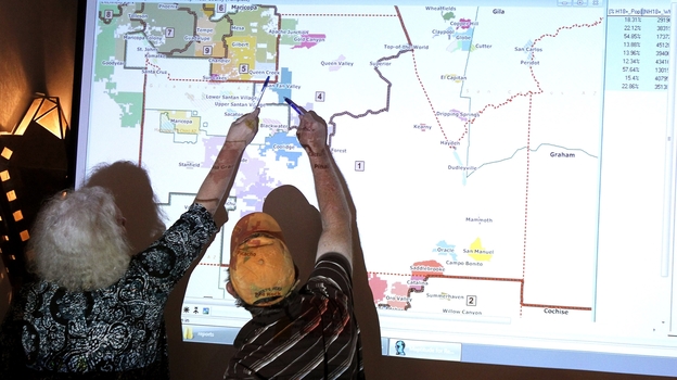 Arizona commission attorney Mary O'Grady (left) and Stephen Miller, a city council member, point to a possible redistricted map in 2011. (AP)