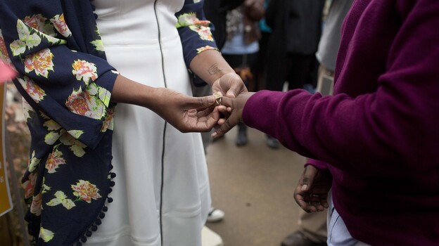 Tori Sisson, left, and Shante Wolfe, right, exchange wedding rings during their ceremony, Feb. 9, 2015, in Montgomery, Ala. They were the first couple to file their marriage license in Montgomery County. Such marriage licenses appear to be on hold again following a state Supreme Court ruling on Tuesday. (AP)