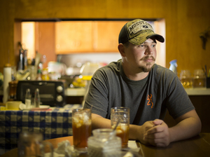 John Coffell sits at his grandmother's table in Hulen, Okla.