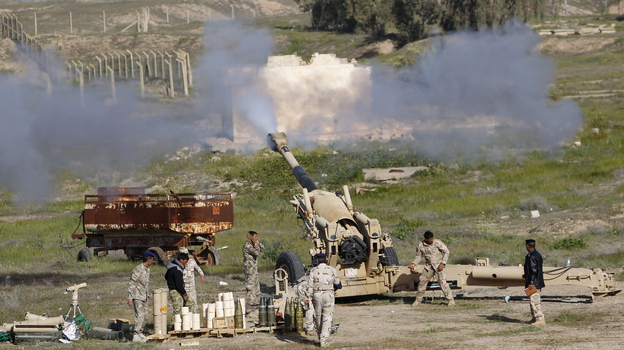 Iraqi security forces and Shiite fighters fire artillery during clashes with ISIS militants in Salahuddin province. The push to retake Tikrit is being aided by Iran, which is providing rockets and other support to Iraq. (Reuters /Landov)